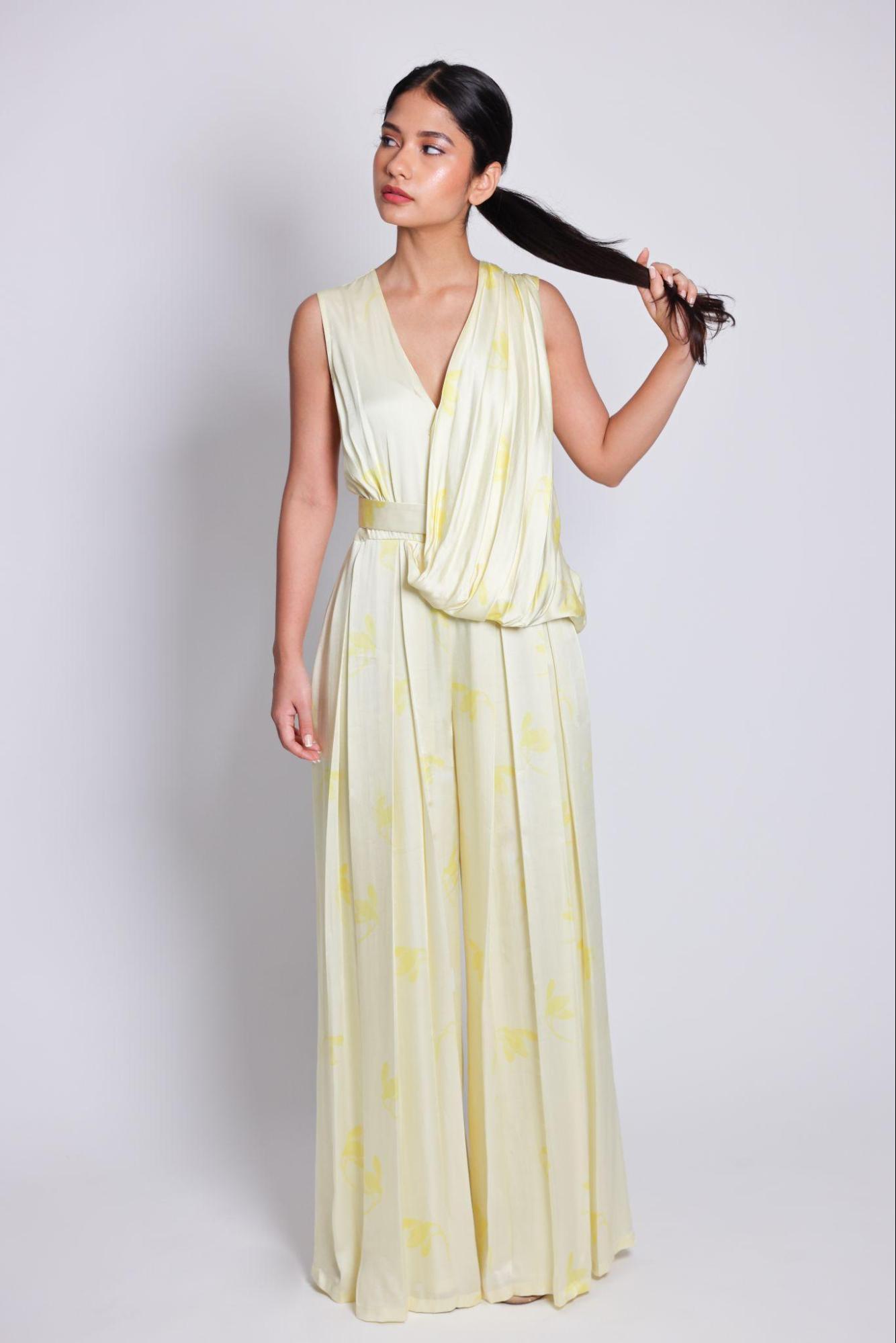 belted jumpsuit | sleeveless jumpsuit with a tulip-like drape. a waist-defining band with hand-embroidered poetry locks and finishes the piece from Arya Giri | Luxury Women's Pret Wear
