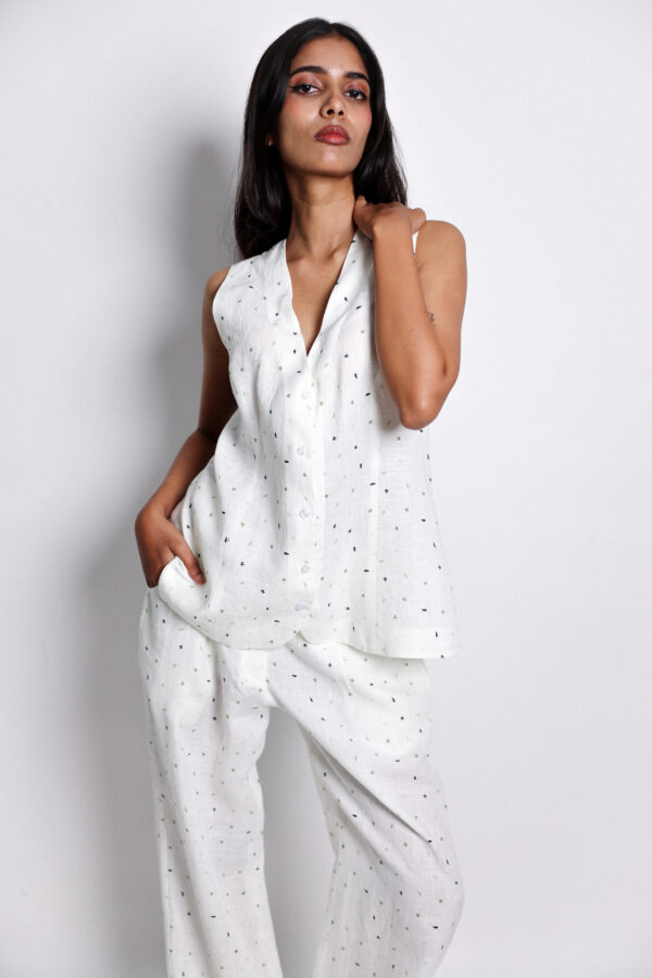 Woman in white sleeveless waistcoat set – Arya Giri lightweight linen outfit designed for all-season wear.